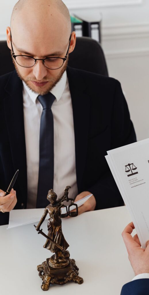 Two lawyers discussing divorce decree documents in a professional office setting.